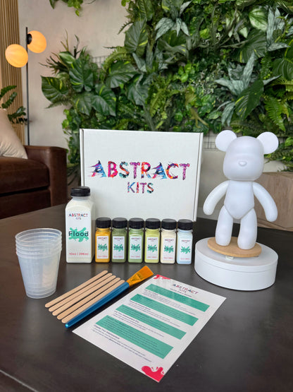 Cub fluid art kit by Abstract Kits, featuring a blank 9-inch acrylic bear sculpture alongside paint, flood, varnish, mixing cups, guide, and all included DIY art supplies.