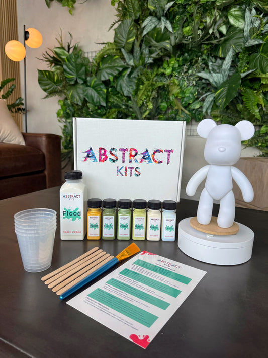 Cub fluid art kit by Abstract Kits, featuring a blank 9-inch acrylic bear sculpture alongside paint, flood, varnish, mixing cups, guide, and all included DIY art supplies.