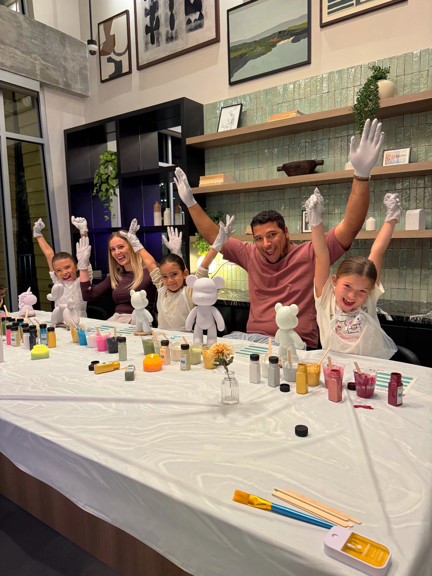 Parents and children bonding through a fun at-home art session with Abstract Kits' family-friendly DIY fluid art kits.