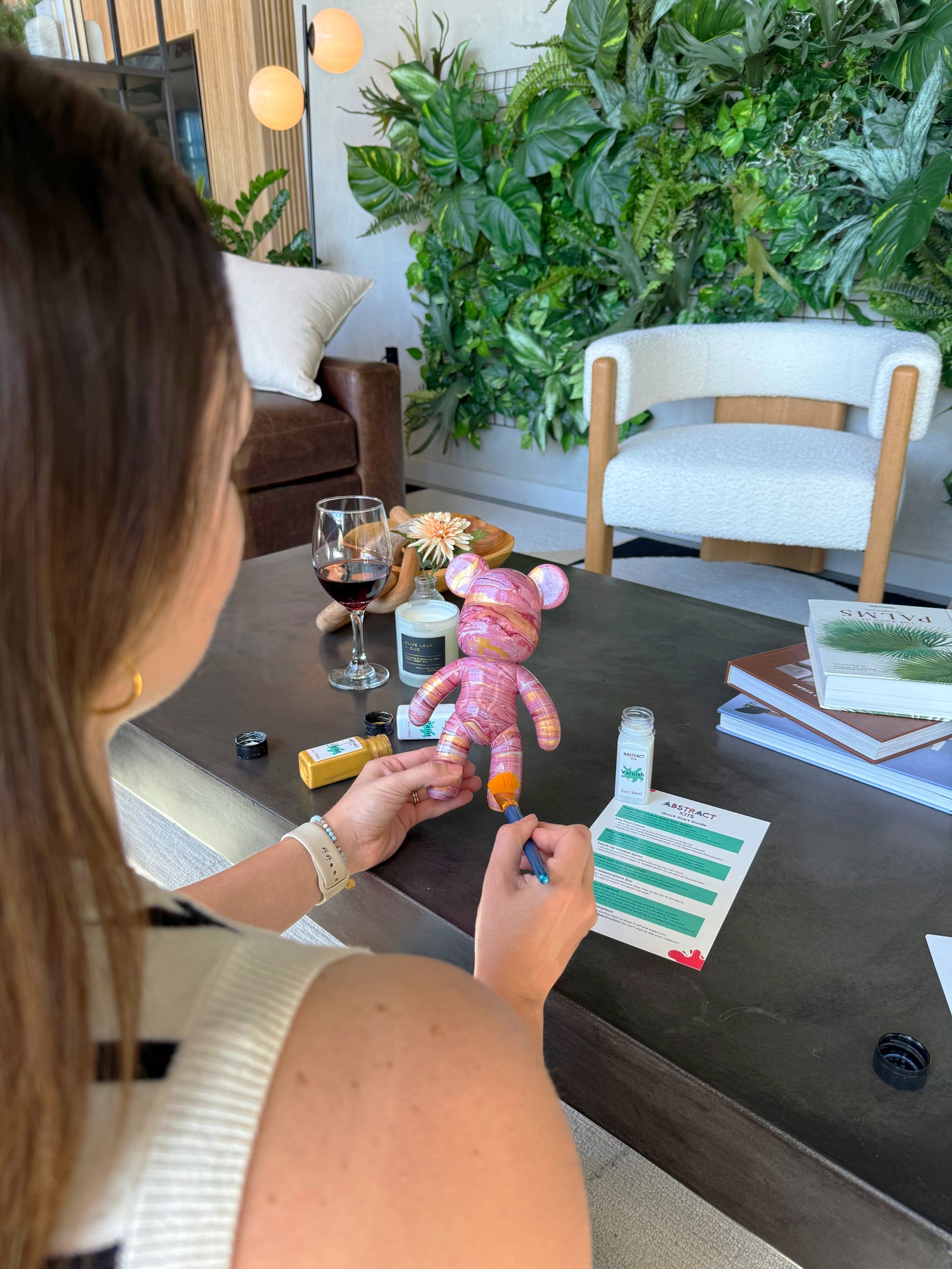 Woman creating calming fluid art alone as a relaxing self-care ritual using Abstract Kits’ beginner-friendly paint kit.